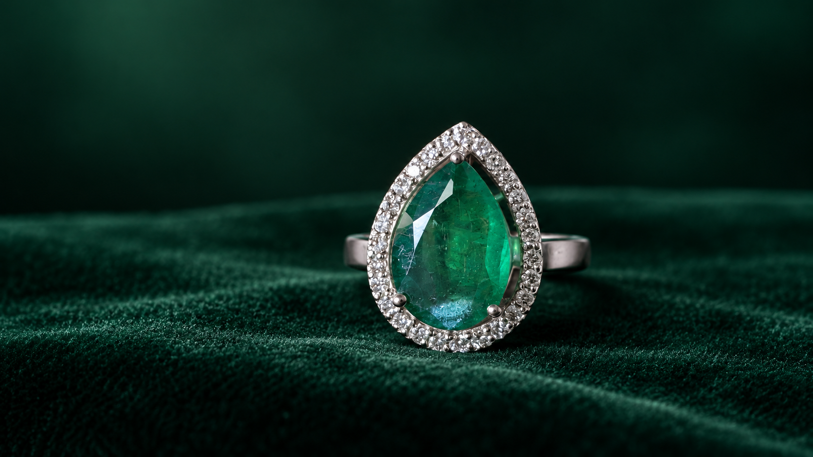 3.3 carat Zambian emerald pear-cut ring with Belgrade diamond halo in 18k gold